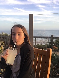 Drinking Lemonade with Coast Backdrop